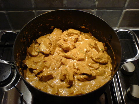 Butter Chicken simmering in a large pot on the stove