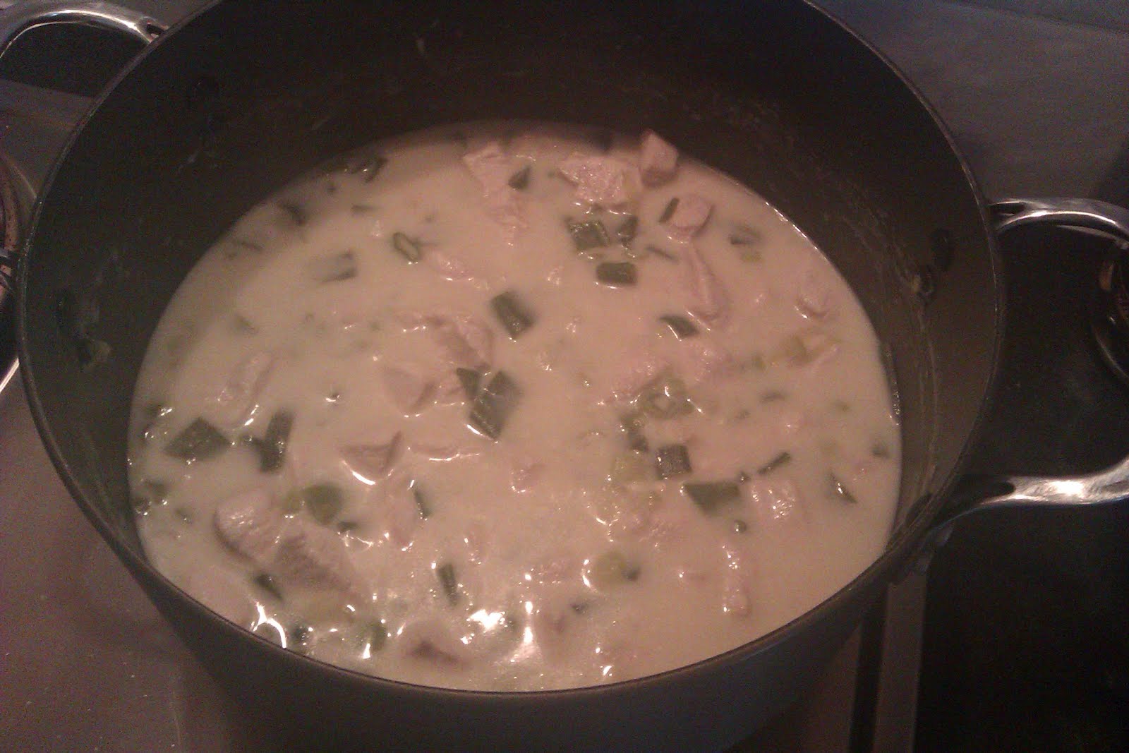 Chicken with Lime and Coconut Milk simmering a large pot on the stove