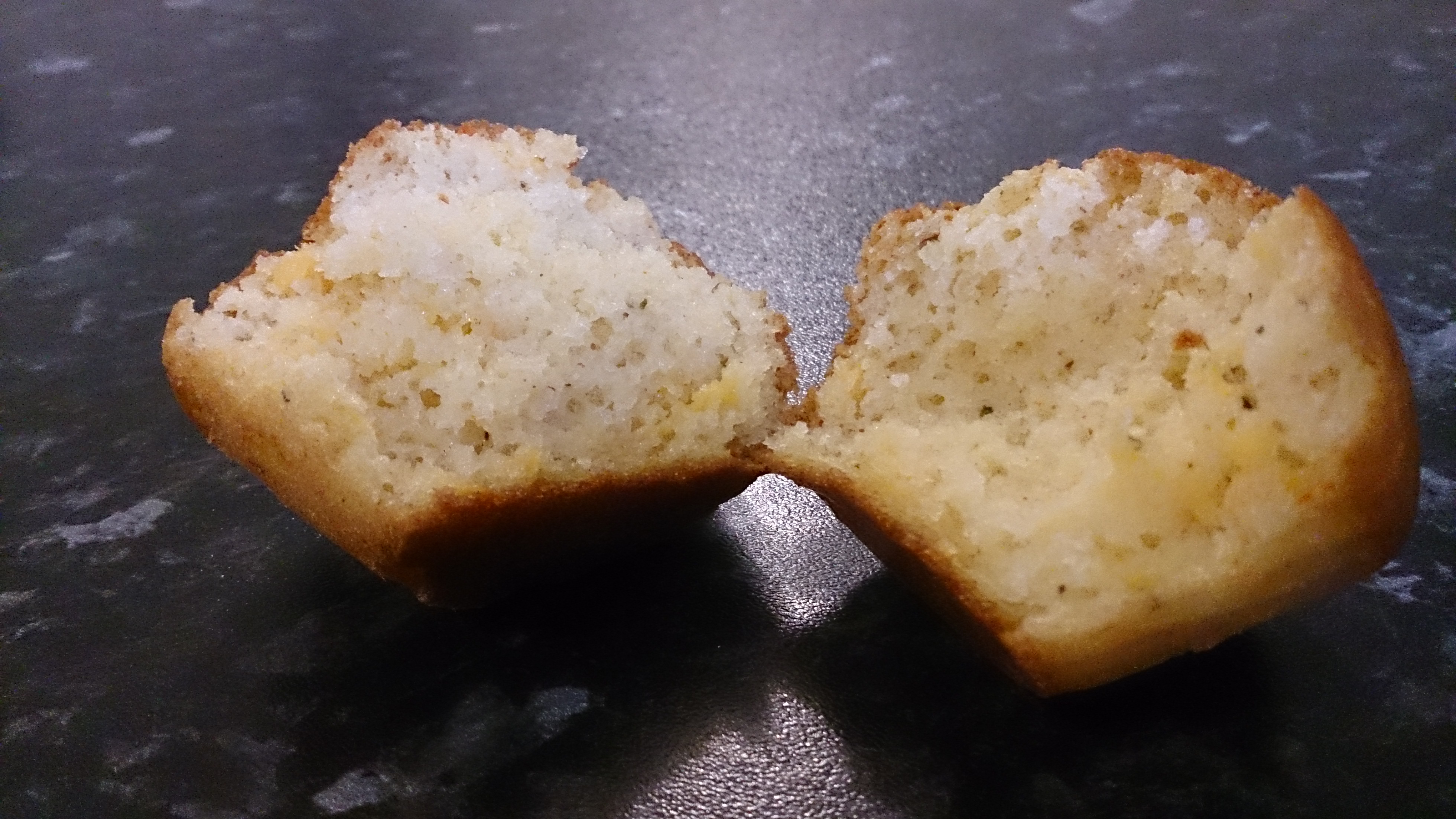 A baked cornbread muffin sliced in half