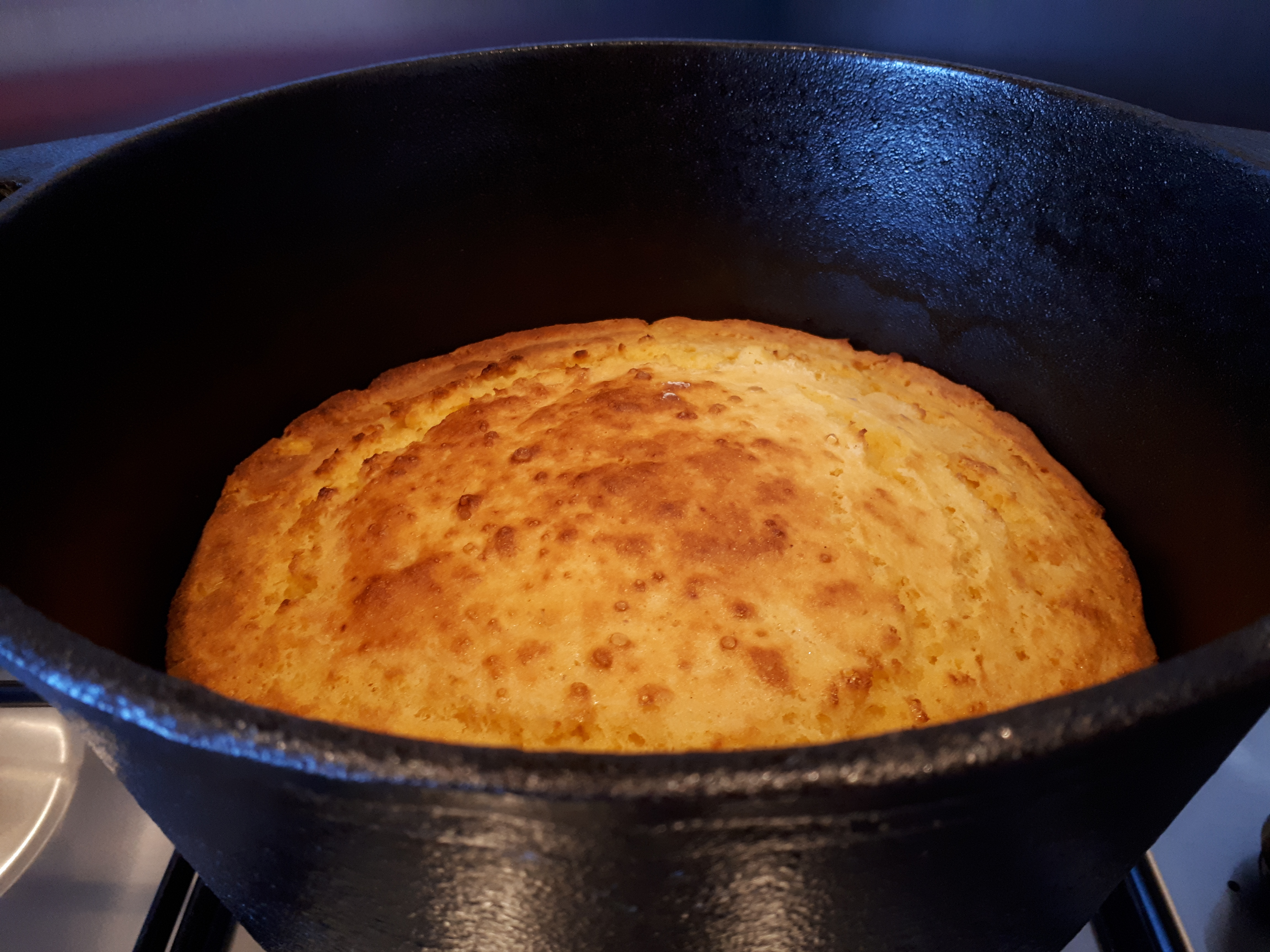 Baked cornbread inside a cast iron Dutch oven