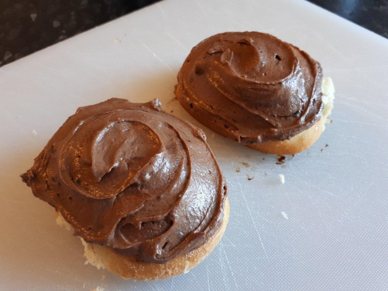 Sourdough Cinnamon Rolls with Mocha Chocolate Frosting on a white cutting board