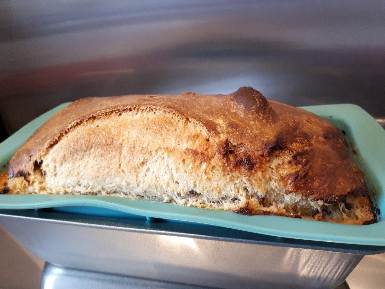 Cinnamon Raisin Sourdough Bread in a blue silicone loaf tin