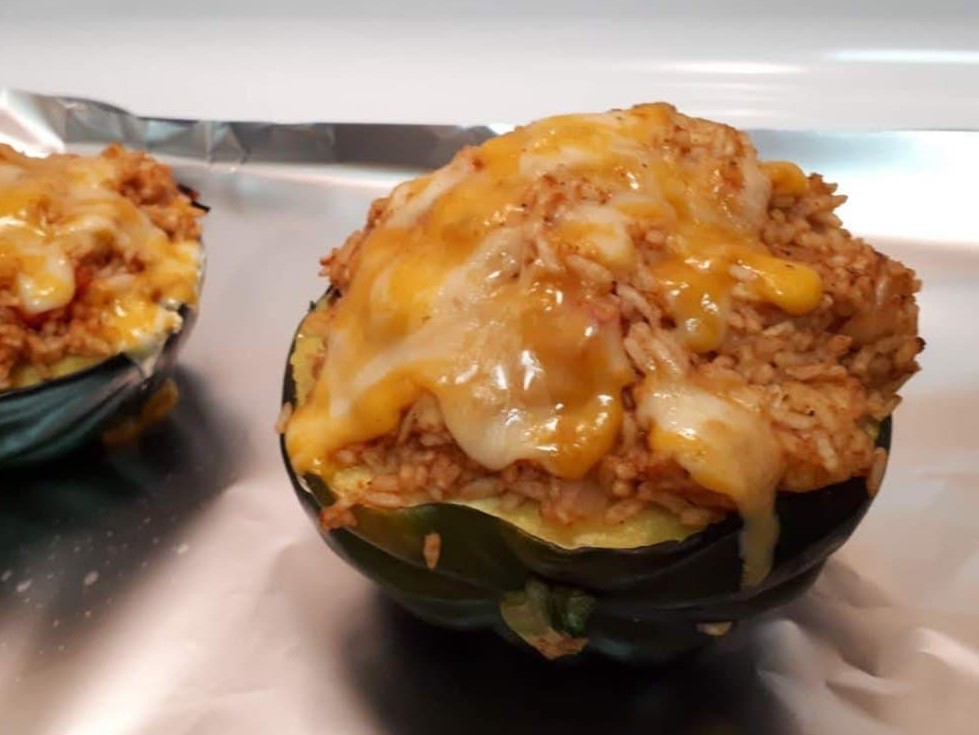 Marshmallow Pecan Stuffed Acorn Squash with a sprinlking of cinnamon powder on top